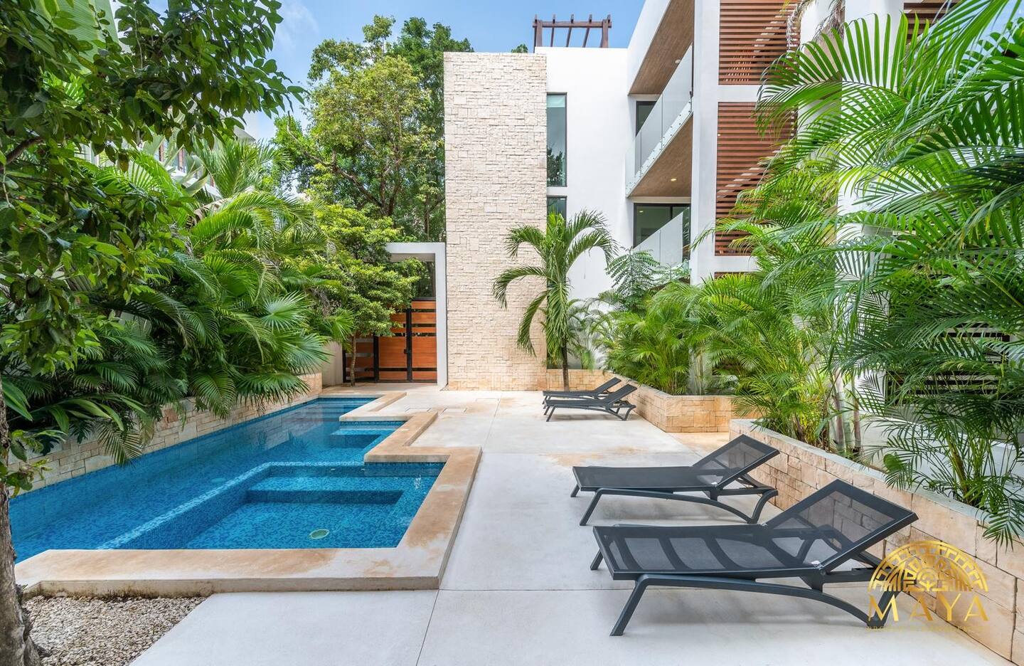 Aldea Zama 2BR Condo with shared pool at dusk